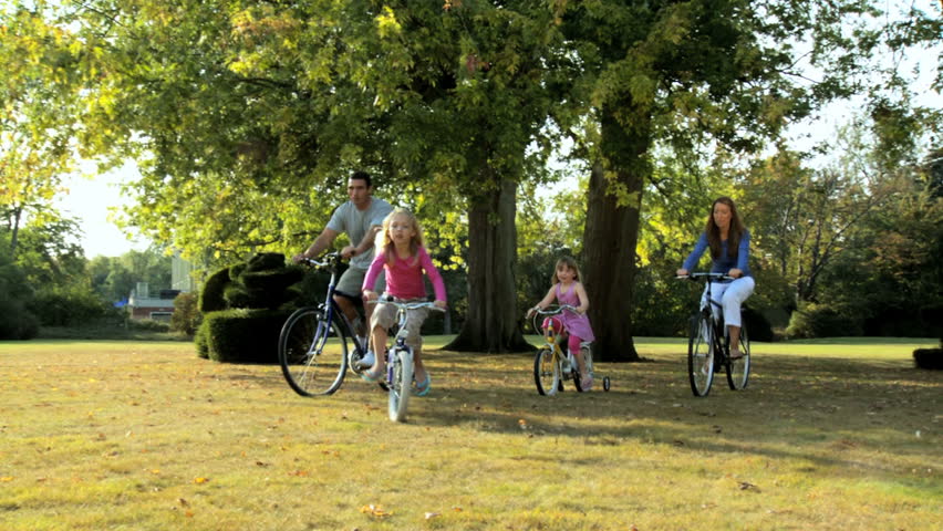 Young caucasian family enjoying cycling together on a summers day