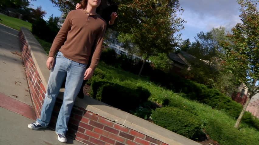 A dating couple frolics on campus.