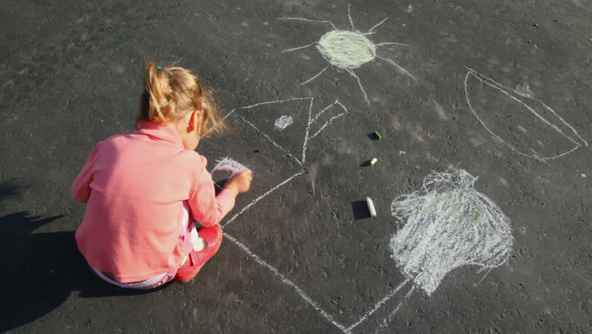 little girl chalking on asphalt 