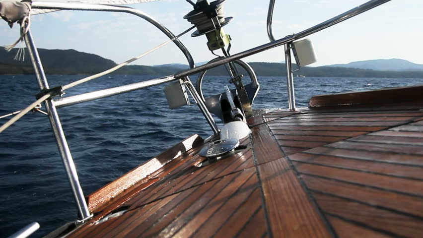 Sailing ship with wave splashing on the deck 