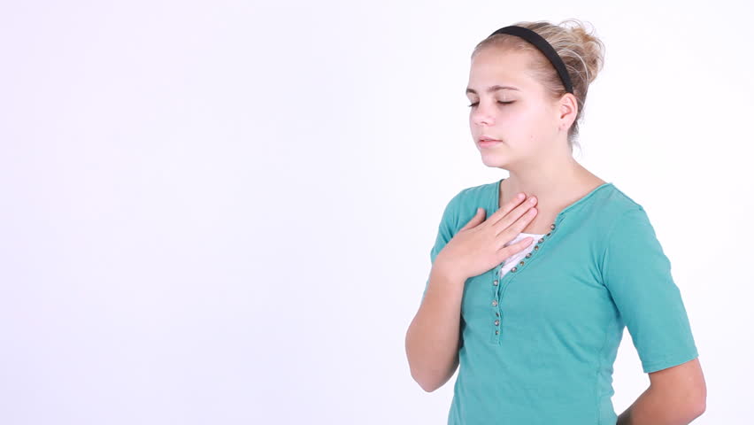 A sneezing young girl sneezing is handed a wipe to clean her hands. Taken on white backdrop with copy space.