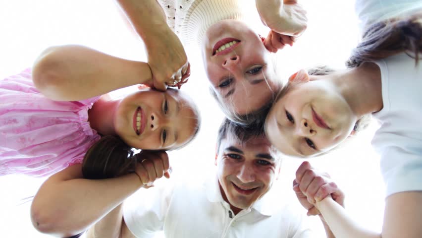 family with two little girls keeps for hands and then disperses 