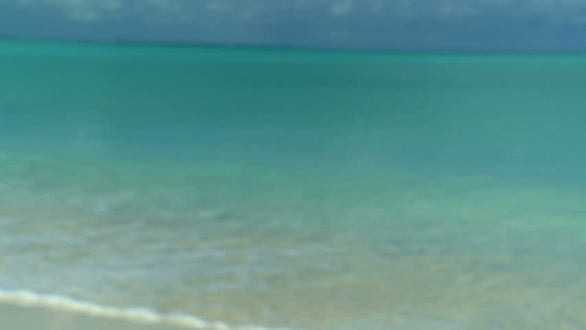 Elegant young female in swimwear  on a beautiful white sandy beach looking at aquamarine waters 60 FPS
