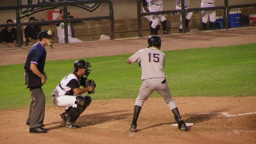 Batter hitting baseball.
 