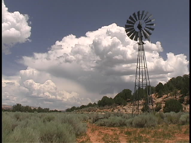 A classic windmill in the desert of southern Utah turns in the wind - frontal view.