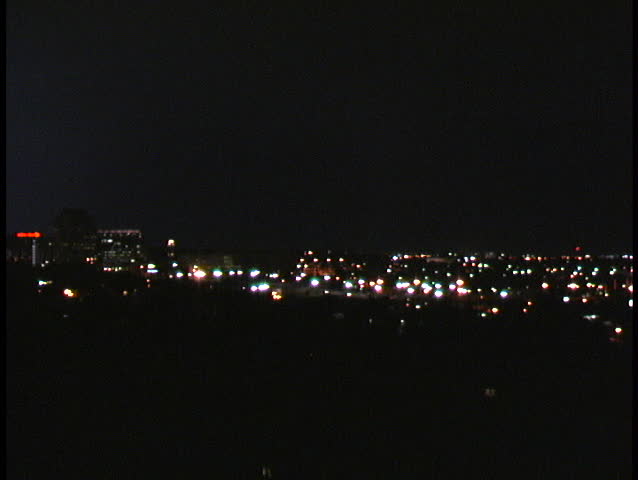 Nighttime lightning storm behind the lights of downtown Colorado Springs.