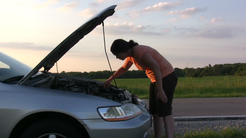 Girl with broken down car on side of road