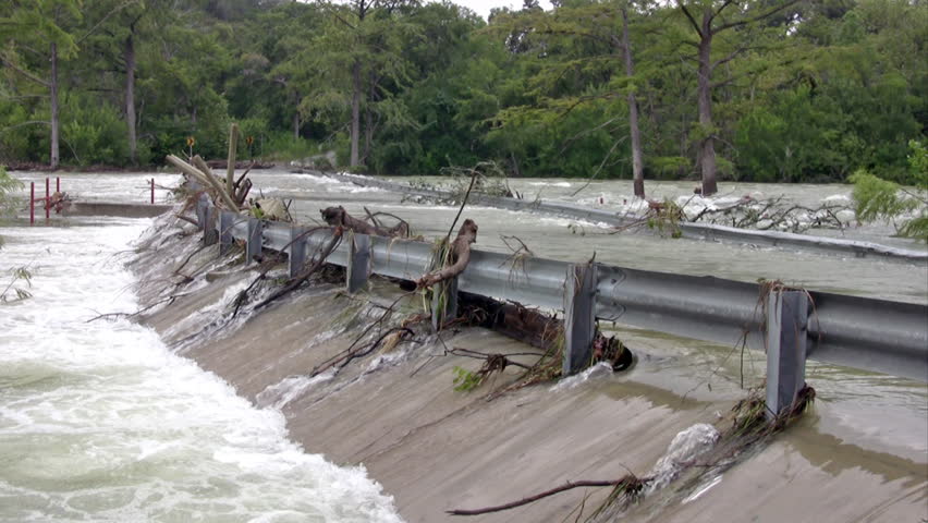 Video of a road and guard rail flooded after a heavy rain storm. Hurricane or tropical storm river surge.