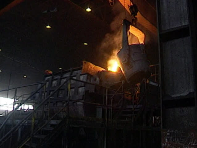 Molten iron being poured out for casting in foundry