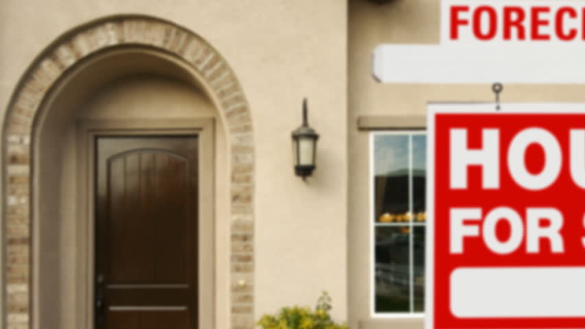 Panning Foreclosure Home For Sale Sign and House.