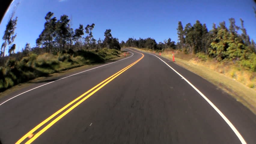 Time-lapse point-of-view fish-eye driving a metalled road through rural countryside