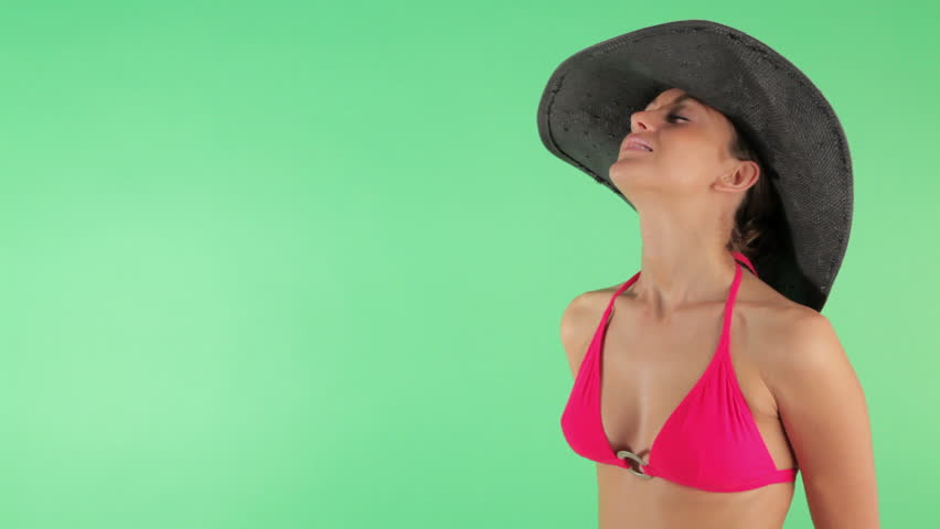Multiple shots of beautiful woman in swimwear and straw hat on green background (sequence)