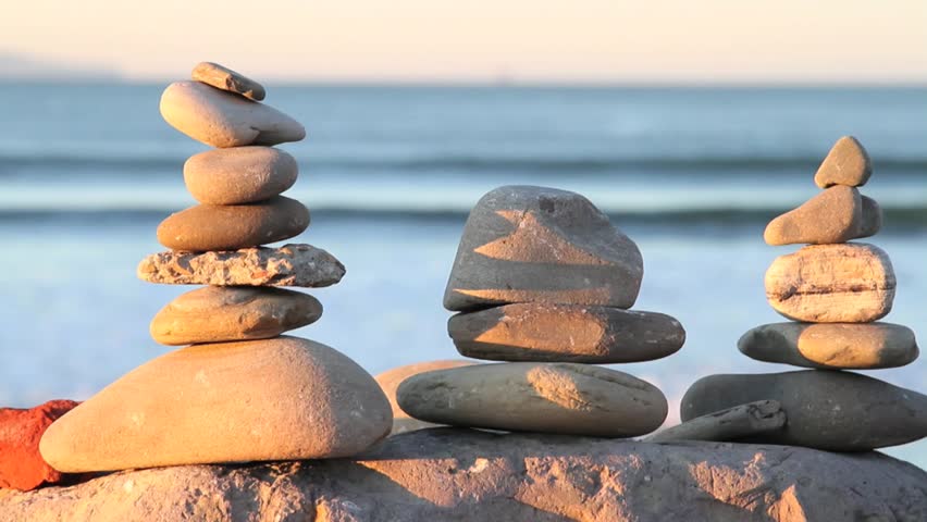 Rocks Balanced, Blue-green Ocean, Surfer Passes by in Background.