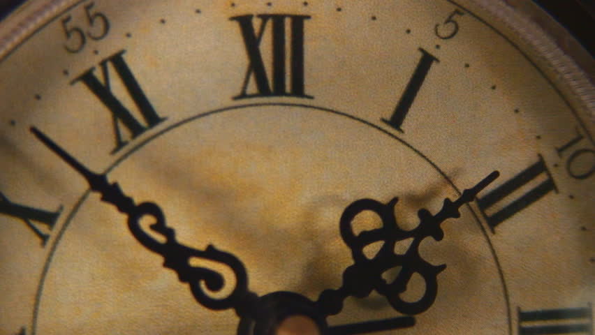 Closeup vintage clock face ticking off seconds in real time