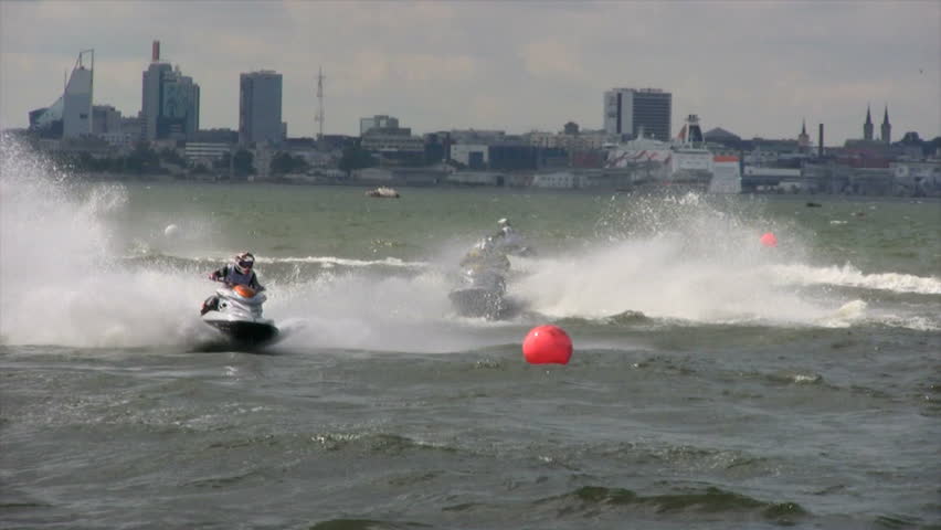 Jet-bikes rushes on waves with big speed so splashing fly