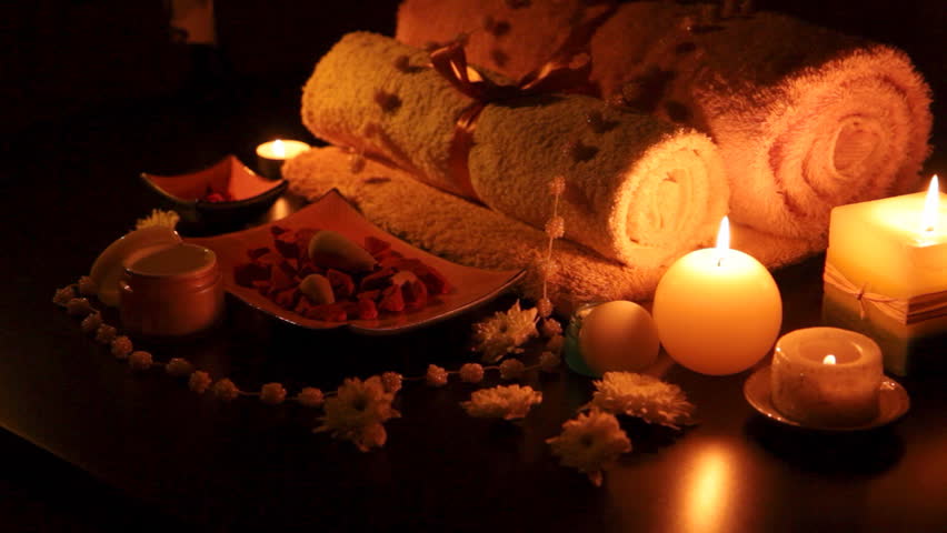 Spa accessories (moisturizer, candles, towels) at therapy center 