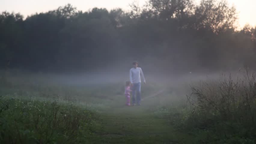 in morning in fog girl with daddy run in park on footpath and smile 