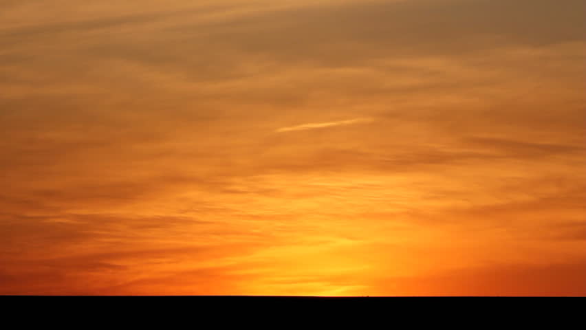 Cars silhouettes on road against sunset