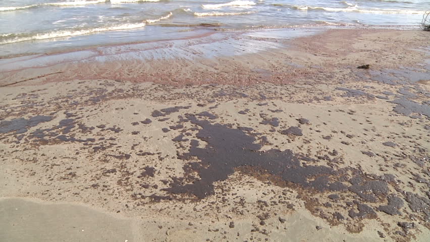 Oil on beach at the beach of Grand Isle, LA  because of oil pollution from the Deepwater Horizon Disaster