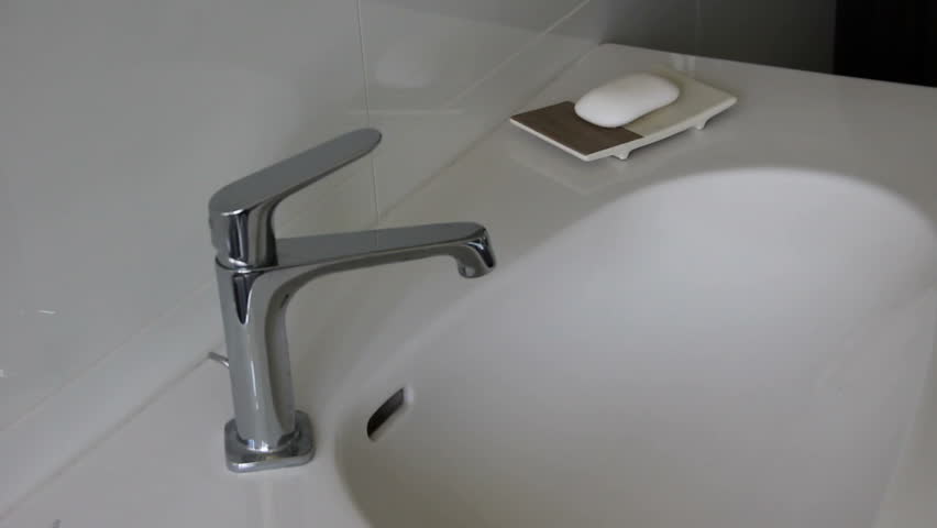 hands being washed with a piece of white soap