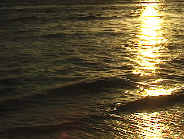 Water glistening and sparkling with golden sunlight. Water background