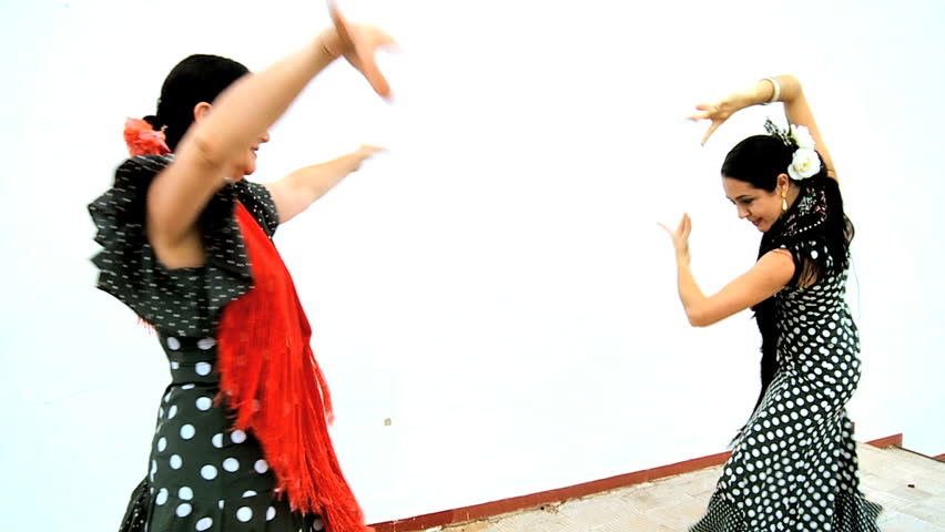 Two ladies in traditional dress dancing dramatic flamenco, Seville, Spain 