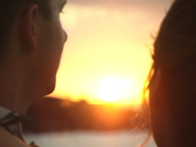 Close up, soft focus of two lovers faces in sunset