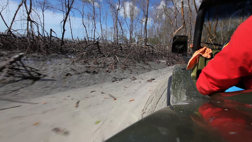 Though ride through sand dunes with a buggy, viewed from vehicle 