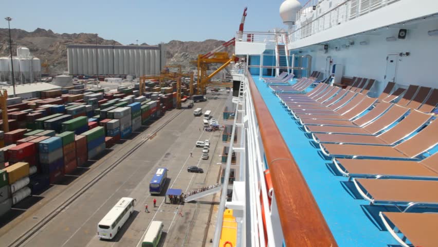 auto-buses near cruise ship in seaport with a lot of containers