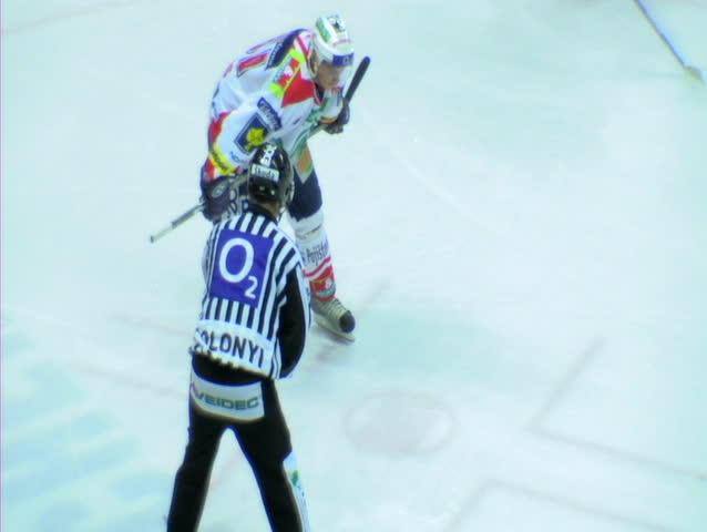 Hockey game, players chasing puck and shooting on goal