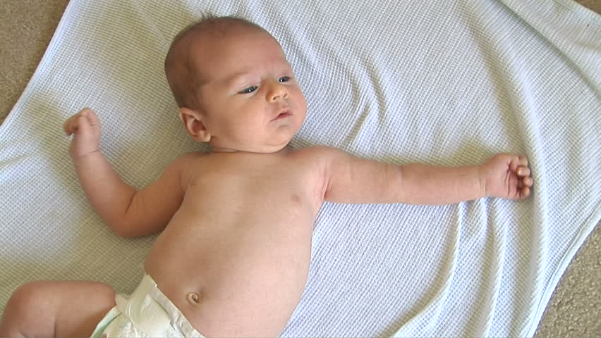 Newborn baby laying on blanket