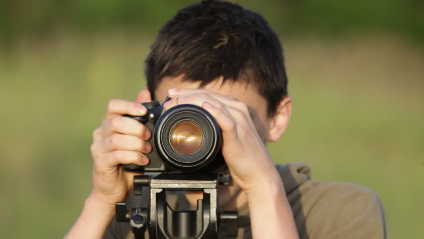 The boy with the camera. Turns the chamber. Removes.