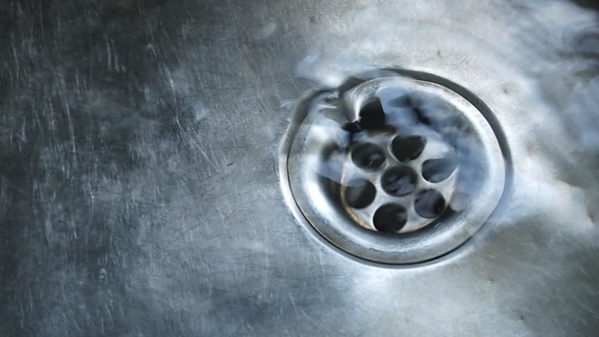 Close-up of kitchen sink with water drops 