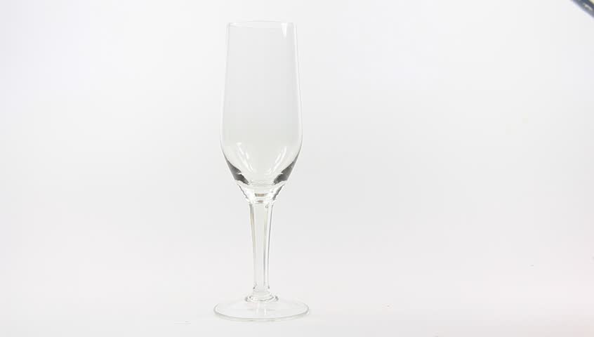 Champagne being poured into glass, isolated on a white background. 