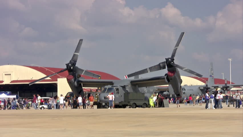 Video of V-22 Osprey aircraft during an airshow at Randolph AFB Texas. Spectators walking about and enjoying the view. Vertical take-off aircraft deployed to war in Iraq.  