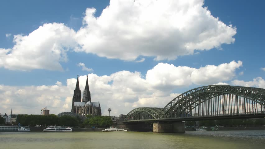 Time lapse clouds over Cathedral in Cologne with Rhine and old bridge