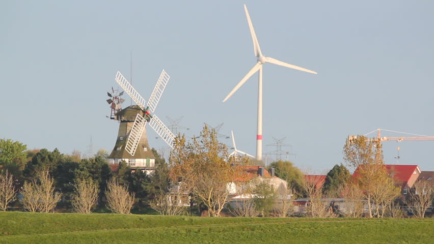 windmill and wind-turbines at carolinensiel, lower saxony, germany