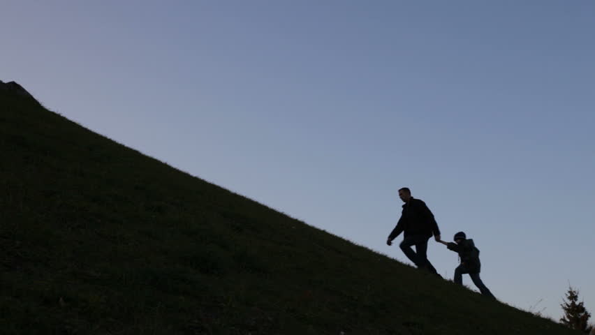 father and son climbing uphill, metaphor