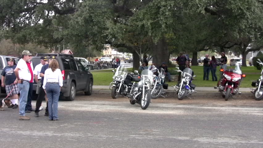 Video of a motorcycle rally Veterans Day. Bikers and citizens ready for ceremony. Handheld movement. 