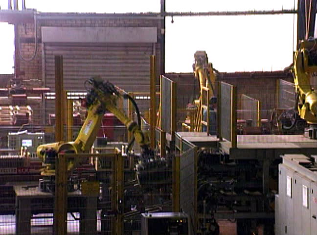Industrial factory automation - robotic arms in work.
