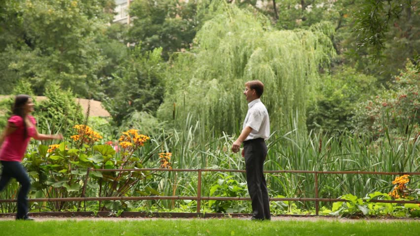 Happy couple embracing and whirling around in beautiful garden
