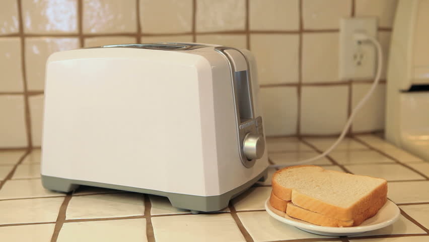 woman putting bread into toaster