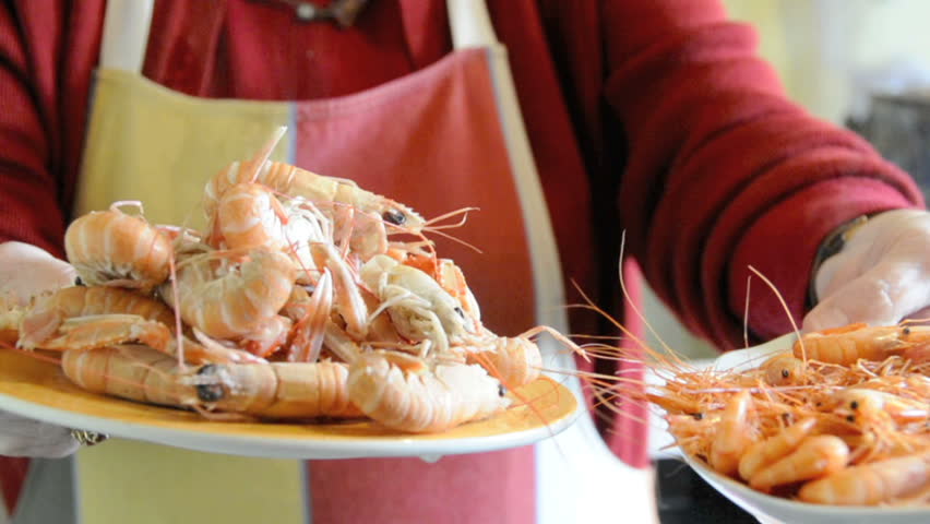 Senior woman cooking seafood in her kitchen