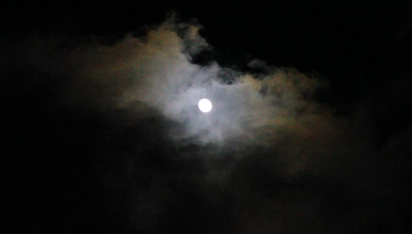 Clouds pass by the full moon 