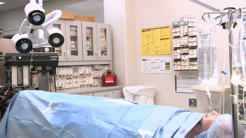 Dolly/ Track into nurse and doctor looking over patient chart