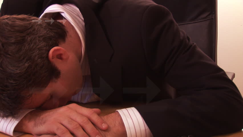Businessman sleeping and profit decline graph