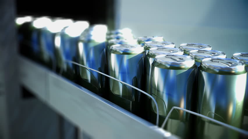 drink cans emerge from factory on conveyor belt 