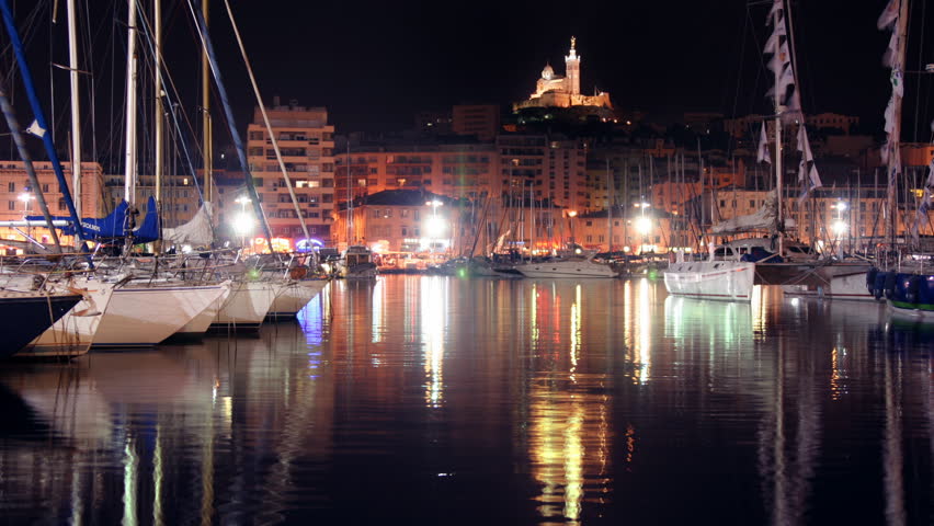 marseille harbour with notre dame de la garde church behind at night