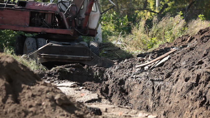 Excavator digs the earth