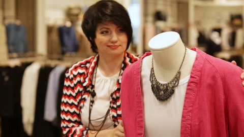 Kazan Tatarstan Russia March 06 2017 Closeup Woman With Short Haircut Turns Dummy And Looks At Pink Cardigan In Entertainment Center Shop On March 06 In Kazan